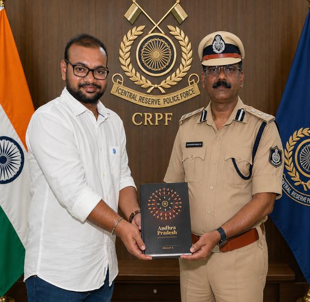 The book being presented to Shri Udaya Bhaskar Billa, IPS, DIG, CRPF